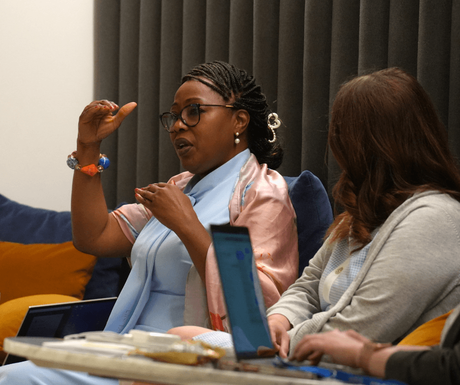 Jumoke Akin-Taylor gesturing with her hands while speaking as a juror at the DBIA Awards Jury