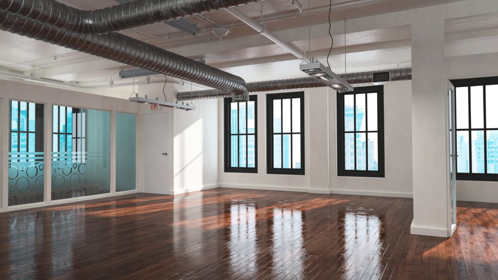 Trendy empty bare open plan industrial loft conversion with multiple windows, exposed metallic pipe ducts and a reflective highly polished wood floor. 3d rendering